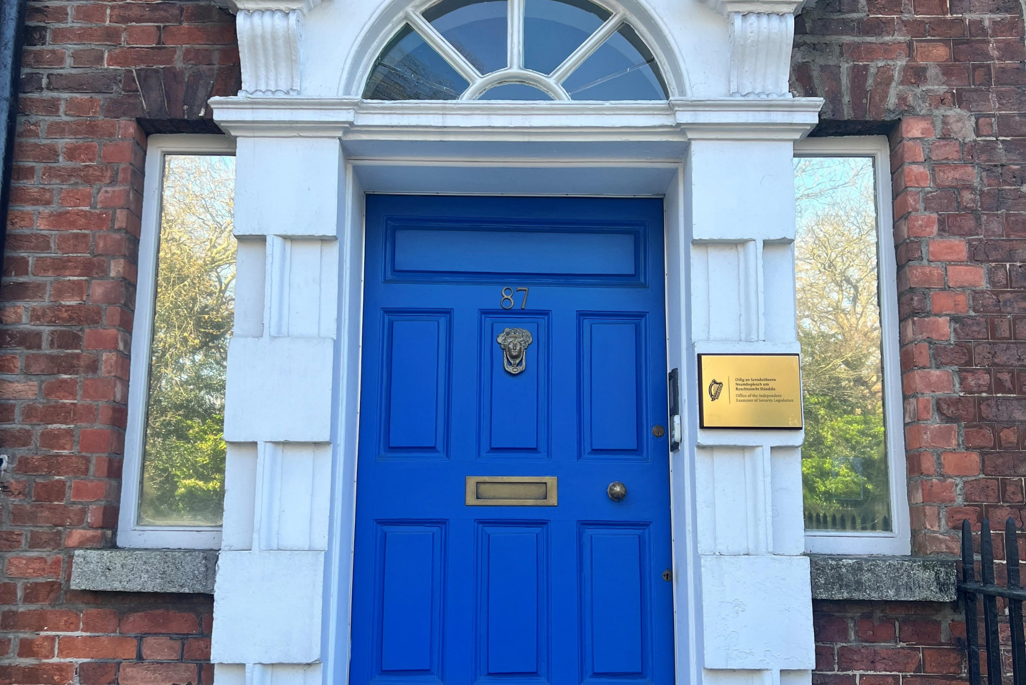 A bright blue door on the front of a stone building